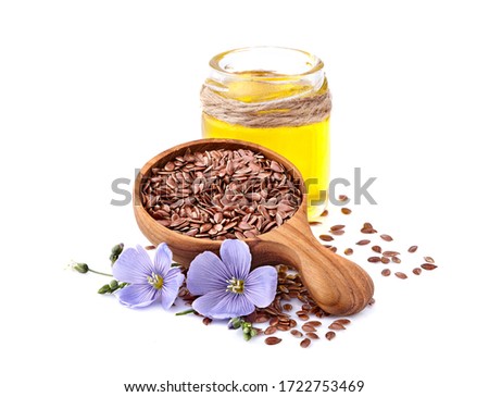 Flax seeds in wooden spoon with oil on white background. Royalty-Free Stock Photo #1722753469