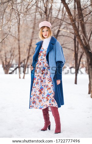 Portrait of a young beautiful teenager girl in winter park
