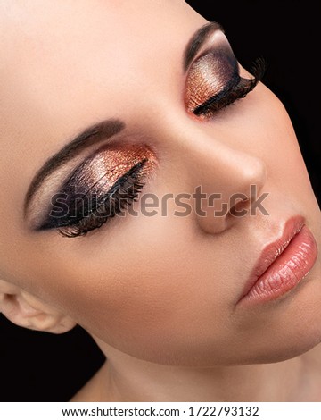 Beautiful bald model wearing glamorous makeup