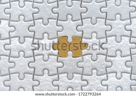 Picture of a paper puzzle with one color different from them