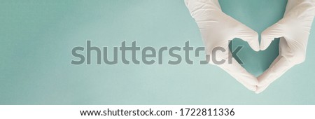 Doctor hands with medical gloves making heart shape, health insurance, organ donation, charity during covid-19 coronavirus pandemic, saving life, thank you and appreciation to doctor Royalty-Free Stock Photo #1722811336