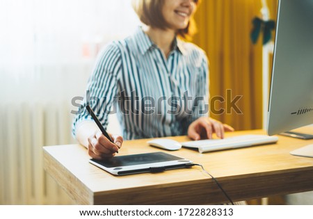 smile woman working at office workplace with digital stylus on computer, online education with internet technology, social isolation work process, female hands graw on portable tablet at home interior