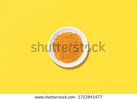 Turmeric powder in a bowl, view from above