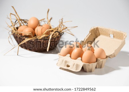 chicken eggs in egg box on white background