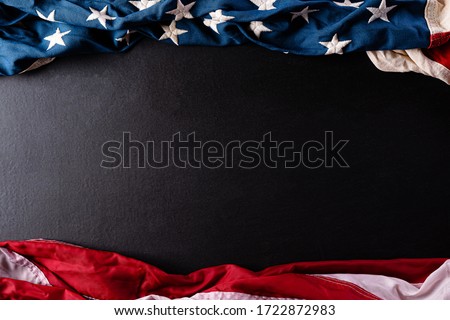 Happy Memorial Day. American flags with the text REMEMBER & HONOR against a black  background. May 25. Royalty-Free Stock Photo #1722872983