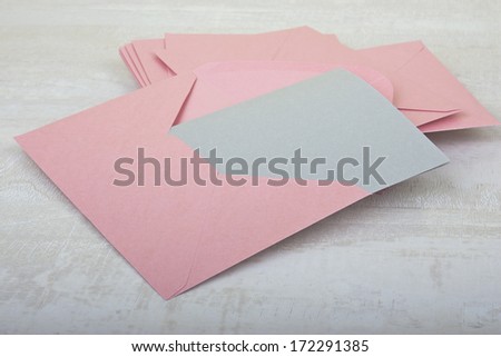 pile of pink envelopes on the table