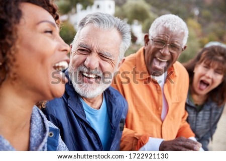Group Of Senior Friends On Hike In Countryside Talking And Laughing Together Royalty-Free Stock Photo #1722921130