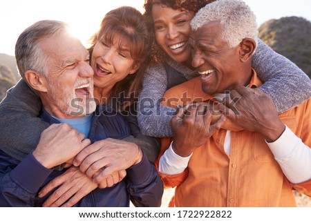 Smiling Senior Friends Having Fun Walking In Countryside Together Royalty-Free Stock Photo #1722922822