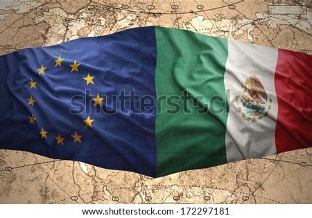 Waving Mexican and European Union flags on the of the political map of the world