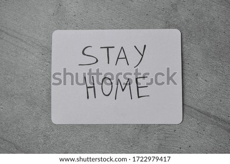 Stay home at the concept of self-isolation during the Covid-19 coronavirus pandemic. Stay home sign on wooden background. Stay on quarantine self-isolation
