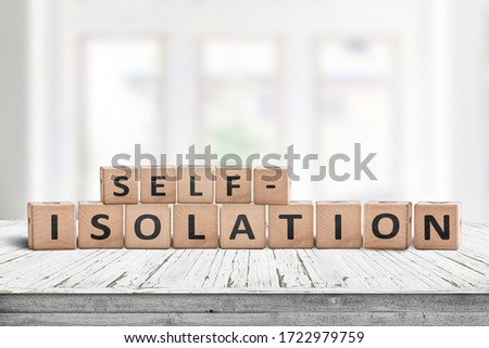 Self-isolation sign on a desk in a bright living room on a sunny day Royalty-Free Stock Photo #1722979759