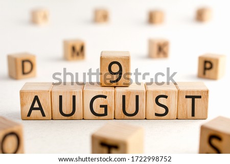 August 9 - from wooden blocks with letters, important date concept, white background random letters around