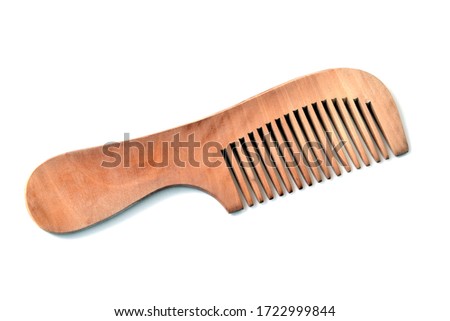 Beige wooden comb on a white background Royalty-Free Stock Photo #1722999844
