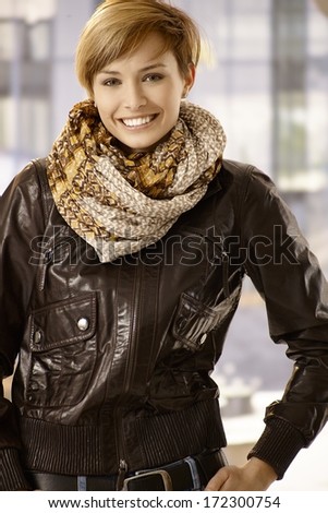 Outdoor portrait of attractive young woman in leather jacket