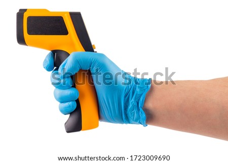 a side view of hand in blue medical latex glove aiming with infrared contactless thermometer isolated on white background