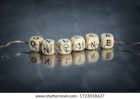 Online text on wooden blocks e-commerce business concept. Conceptual inscription strung on a thread with reflections.
