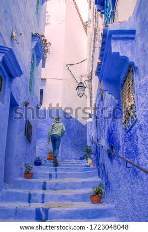 Walking across the blue street of Chuefchaouen in Morocco
(The blue pearl)