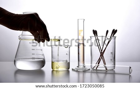 Oil pouring in water, Equipment and science experiments, Formulating the chemical for medicine, Organic extract pharmaceutical, Alternative medicine concept. Royalty-Free Stock Photo #1723050085