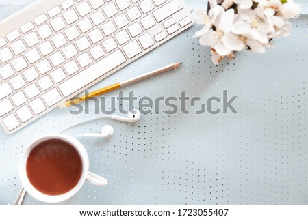 White office desk with smartphone with blank screen mockup, laptop computer, cup of coffee and supplies. Top view with copy space, flat lay.
