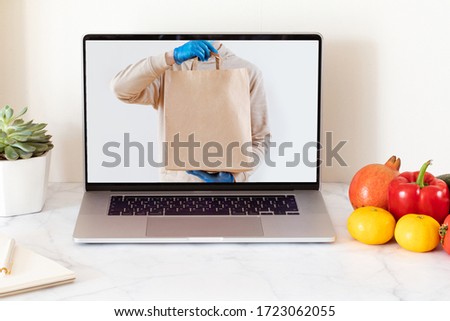 Online Food delivery concept with white blank screen laptop. Grocery delivery service. Home office.