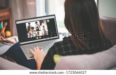 Back Side View of Asian Business Woman Meeting with Multiethnic Business People and VDO Conference Live Streaming in Work from Home Concept - Social Distancing in Coronavirus(Covid-19) Outbreak Royalty-Free Stock Photo #1723066027
