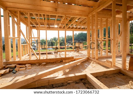 Interior frame of new wooden house under construction Royalty-Free Stock Photo #1723066732