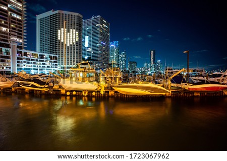 Miami, Florida skyline at night. Miami City Skyline viewed from Biscayne Bay. Bayside Marketplace Miami Downtown behind MacArthur Causeway shot from Venetian Causeway