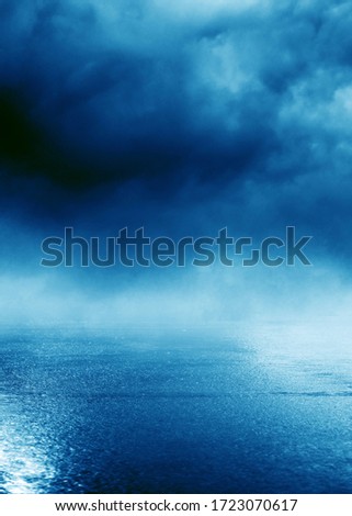 Blue blurred background of the night sky, reflection of the lights of the night city on the pavement. Smoke, fog, smog.