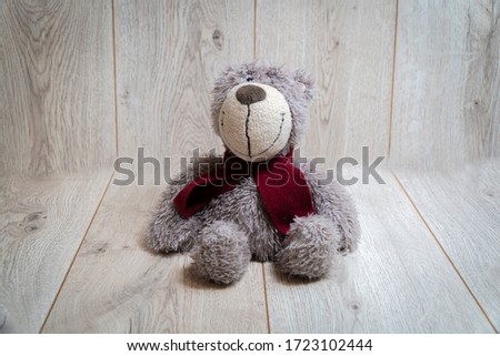 Soft teddy bear on a wooden background