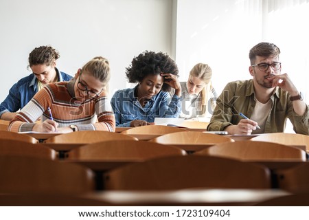 Group of university students taking a test in a classroom.Educational concept.	
 Royalty-Free Stock Photo #1723109404