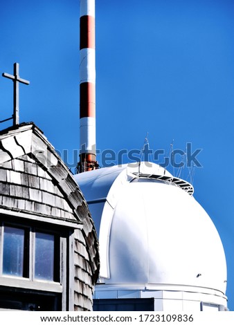Wendelstein - chapel, observatory telescope and telecommunication tower on blue sky background 