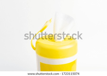 A close-up shot of an open yellow push top cap of a disinfectant wet wipes product container set on plain white background.