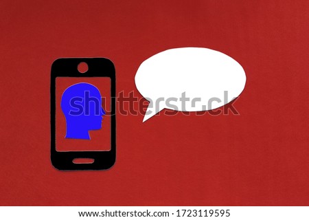 The silhouette of a person's head inside the phone, an oval for text on a red background. Concept of information transfer.
