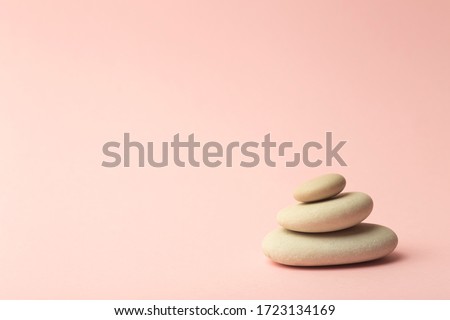 Zen background pink color with Japanese stones (stone towers) for spa, meditation and relaxation. 