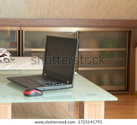 laptop on a glass table. remote work at home. freelance. close-up