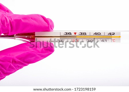 Medical thermometer in hand in medical gloves. Health concept. Epidemic, coronavirus, symptoms. Epidemic coronavirus 2019-nCoV.