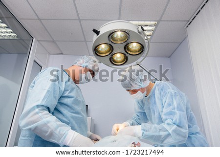 Operation in a modern operating room close-up, emergency rescue and resuscitation of the patient. Medicine and surgery
