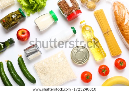 Food supplies for the period of quarantine on white background. Set of grocery items from canned food, vegetables, pasta, cereal. Food delivery concept. Donation concept. Top view. Royalty-Free Stock Photo #1723240810