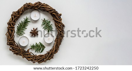 Base for Christmas wreath or nest for Easter on white background, candles and branches of spruce. Handwork with creativity, needlework with children.DIY, decoration to holidays. Flatly with