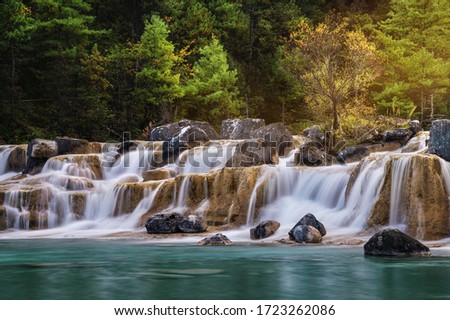 Waterfall in Blue Moon Valley in Jade Dragon Snow Mountain, Lijiang, Yunnan China.