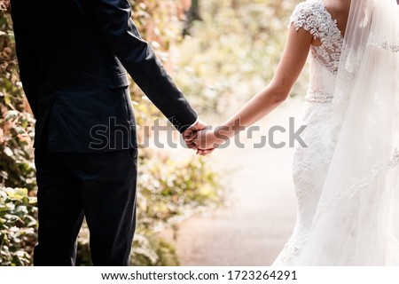 The hands of the bride and groom touch each other.Gentle touches, hugs. Wedding, celebration, ceremony Royalty-Free Stock Photo #1723264291