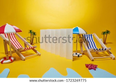 Beach hammocks separated by safety distance. Safety distance for virus prevention. The image contains space for a text.