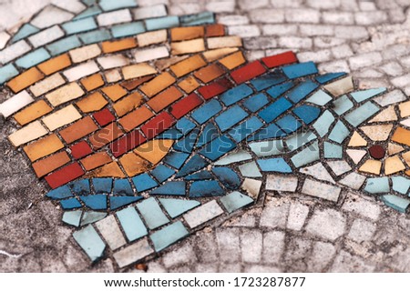 Weathered sidewalk pavement mosaic tiles.