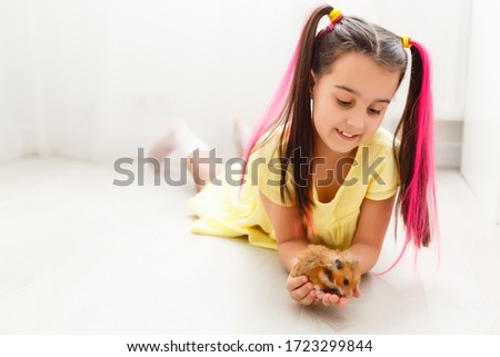 My little pal - girl holding her hamster in palms Royalty-Free Stock Photo #1723299844