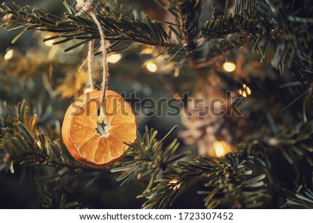 Zero waste christmas concept. Christmas tree decorated with ornaments made of natural materials - slices of dried orange and cones Royalty-Free Stock Photo #1723307452