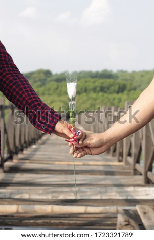 A man gives flowers to women