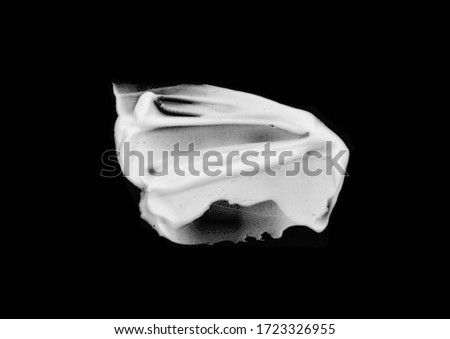 whipped cream or meringue isolated on black background. 