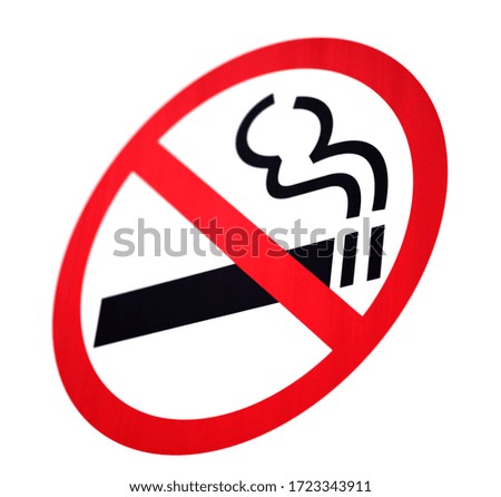 The no Smoking sign was photographed at an angle. The background is uniform. The edges of the sign are blurred.