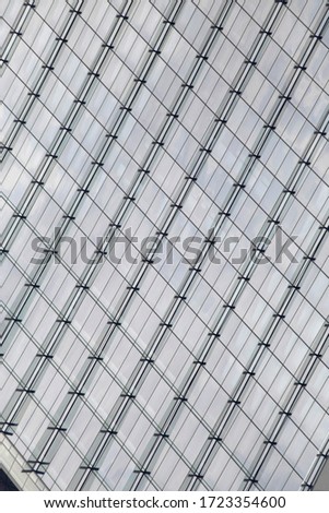 Reworked photo of steel-and-glass wall of skyscraper. Abstract modern architecture of minimalist business building exterior. Hi-tech geometric background with linear pattern in diagonal composition.