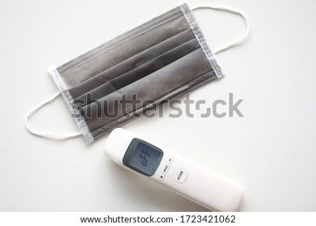 Coronavirus prevention medical masks and thermometer digital on floor